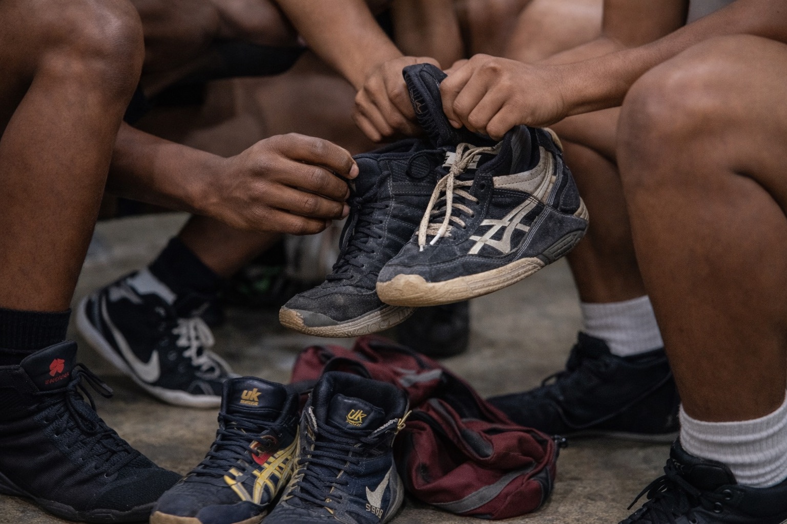 Student-athletes listening together in wrestling practice